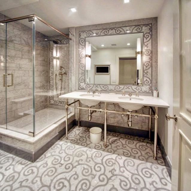 Marble bathroom with a glass shower and mosaic floor