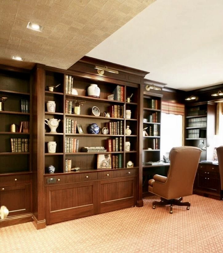 Dark wood library with floor-to-ceiling built-in bookcases