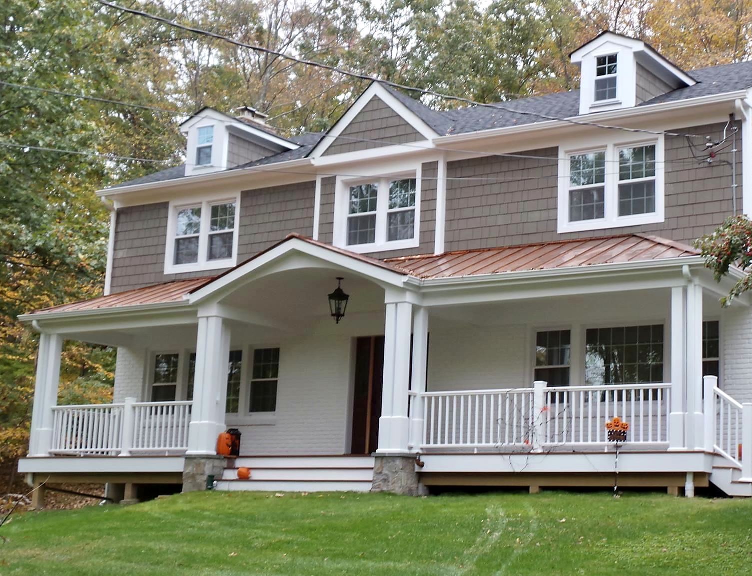 Gray shingled house with a white-columned front porch